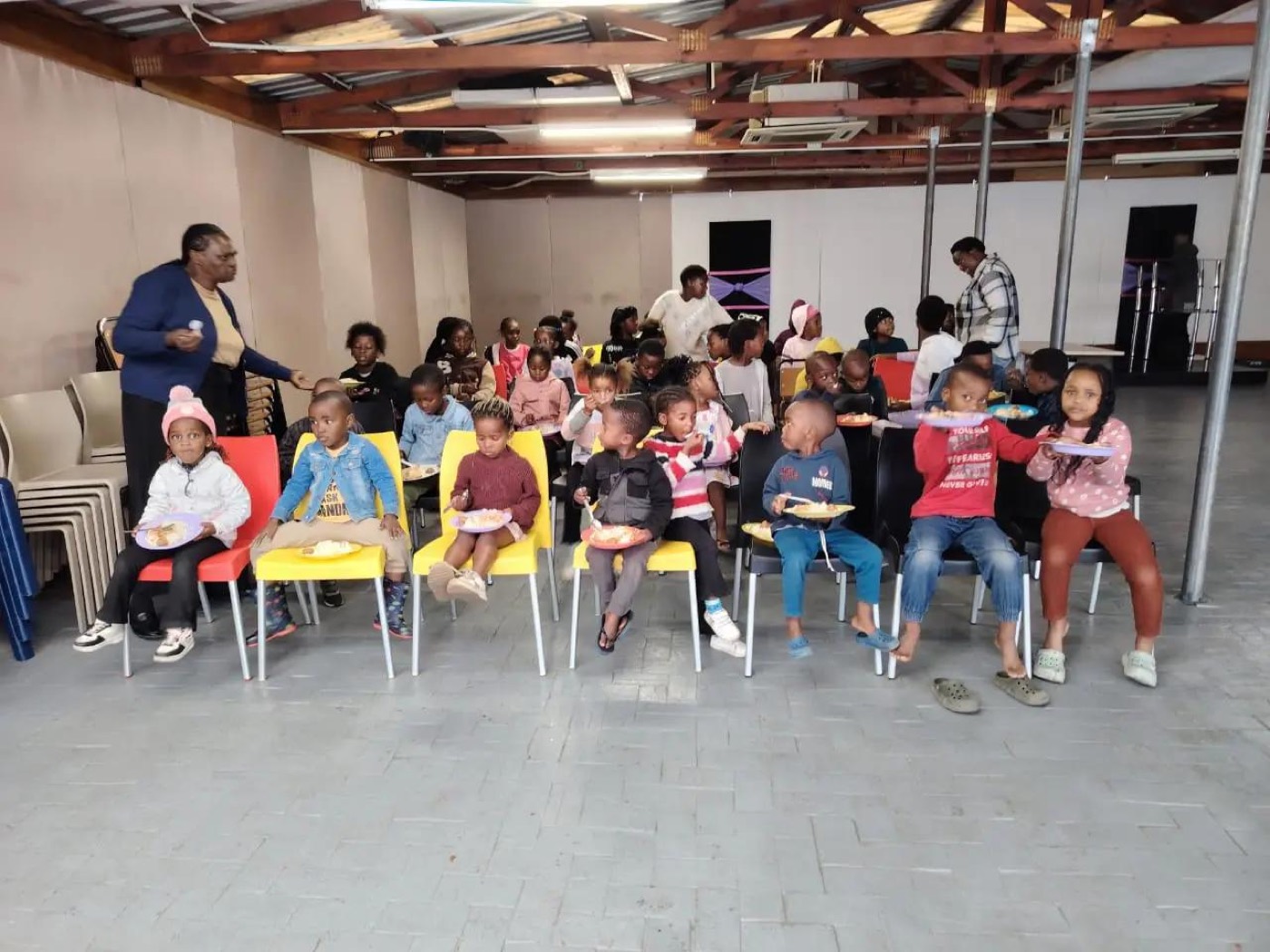 A church hall filled with children eating together